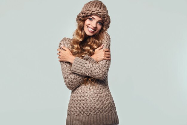 Portrait of beautiful smiling blond woman in sweater