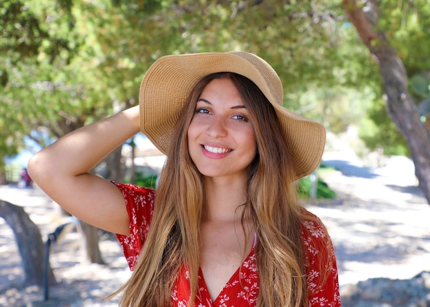 Portrait of a beautiful smiling woman wearing red dress