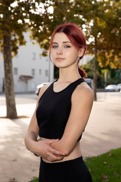 Portrait of a beautiful sports model girl with red hair