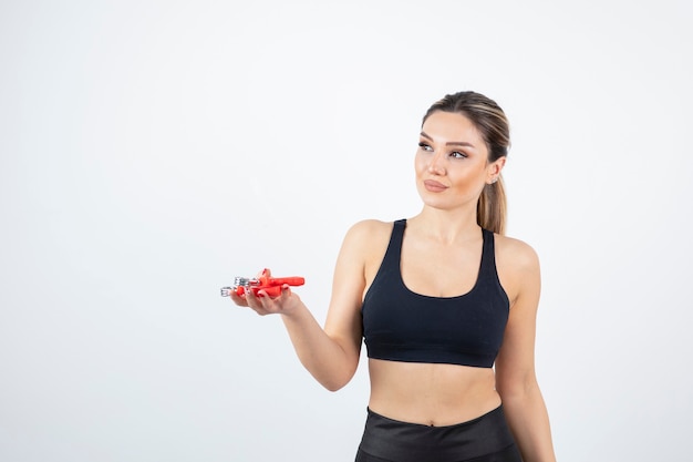 Portrait of beautiful sporty woman with hand expander.  