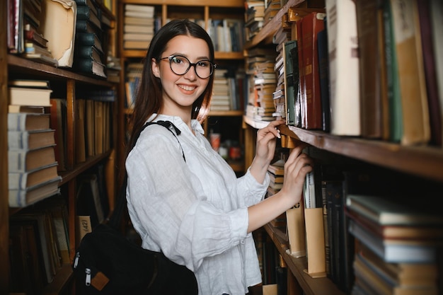 Portrait of a beautiful student in a library