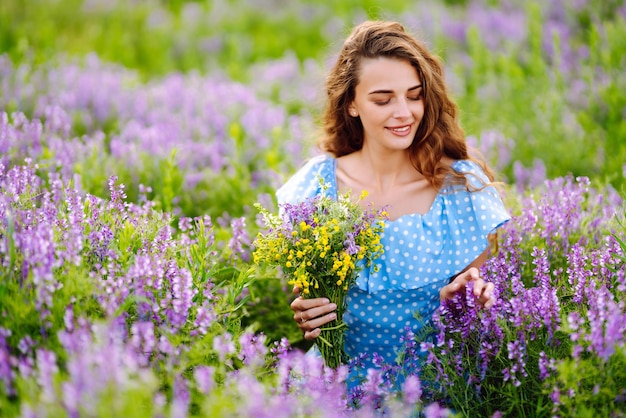 Portrait of beautiful woman in amazing in a blooming field Nature vacation relax and lifestyle