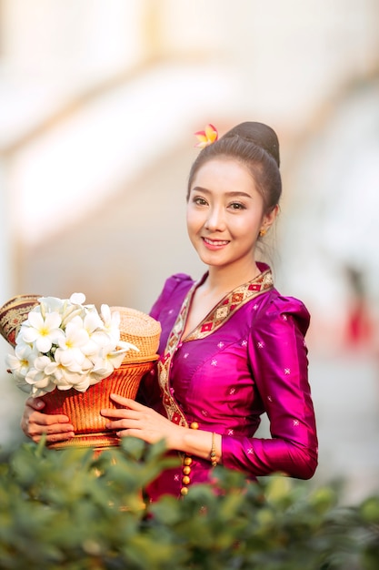 Portrait of a beautiful woman in ancient Lao national costume Who are ready to make merit