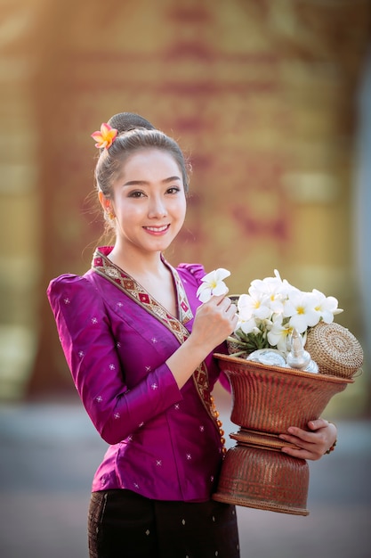 Portrait of a beautiful woman in ancient Lao national costume Who are ready to make merit