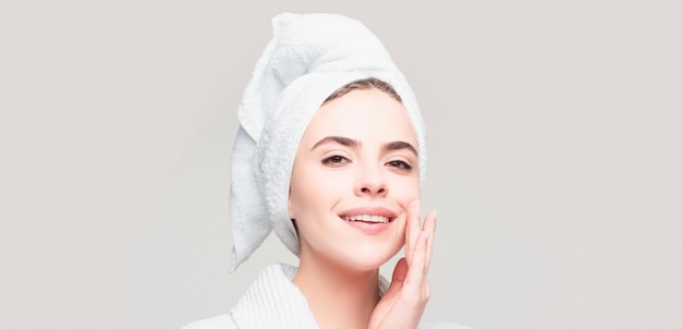 Portrait of beautiful woman applying cream to face for skin care cropped portrait isolated with copy