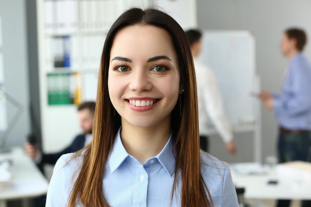 Portrait of a beautiful woman on background of business people