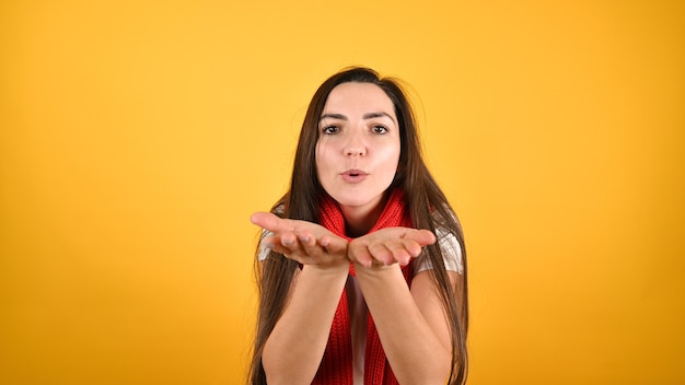 Portrait of beautiful woman blowing kiss