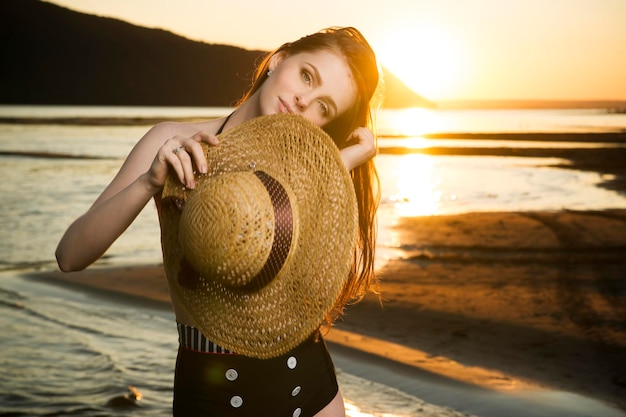 Portrait of beautiful woman close up on a background of a sunset