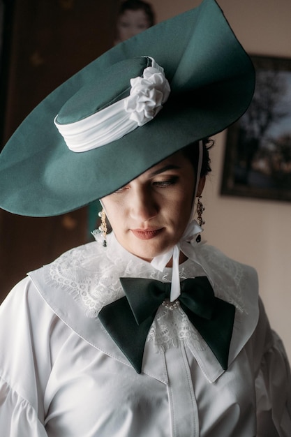 Portrait of beautiful woman in green vintage hat veil s early s clothing