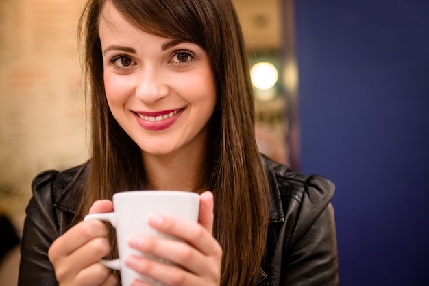 Portrait of beautiful woman having coffee