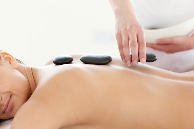 Portrait of a beautiful woman having a massage with stones 