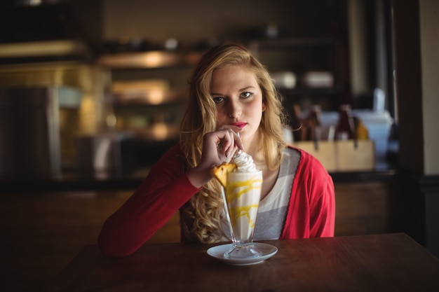 Portrait of beautiful woman having milkshake