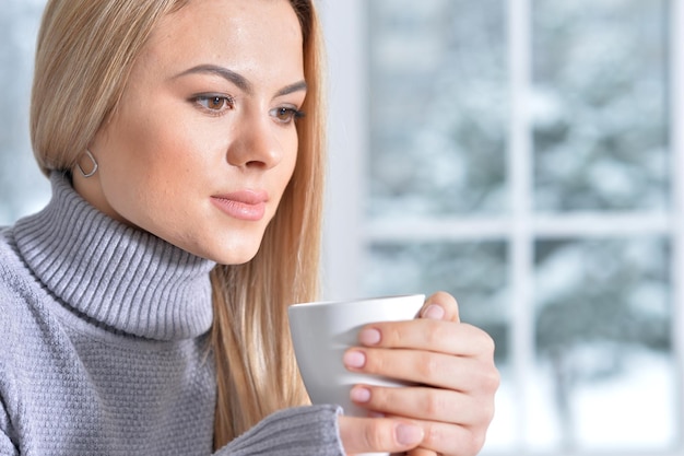 Portrait of a beautiful woman holding cup