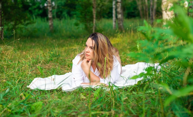 Portrait of beautiful woman laying on grass