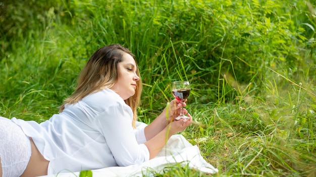 Portrait of beautiful woman laying on grass