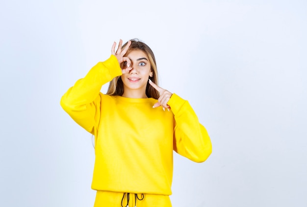 Portrait of beautiful woman model standing and posing in yellow t-shirt