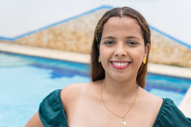 Portrait of a beautiful woman in the pool looking at the camera