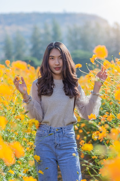 Portrait of a beautiful woman poses for photography Visit the Yellow Flower Fields at Jim Thompson Farm