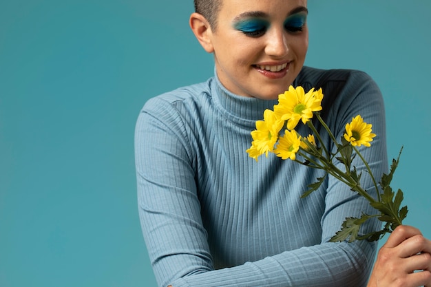 Portrait of beautiful woman posing in a turtleneck with yellow flowers