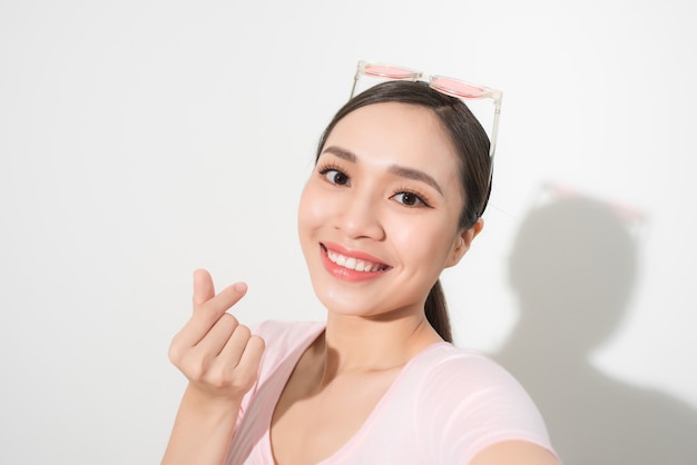 portrait of beautiful woman smiling with white teeth and making selfie, photographing herself