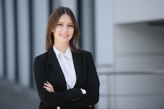 Portrait of a beautiful woman on the street with her arms crossed on her chest