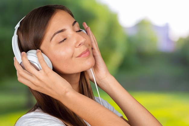 Portrait of a beautiful woman student listening to music