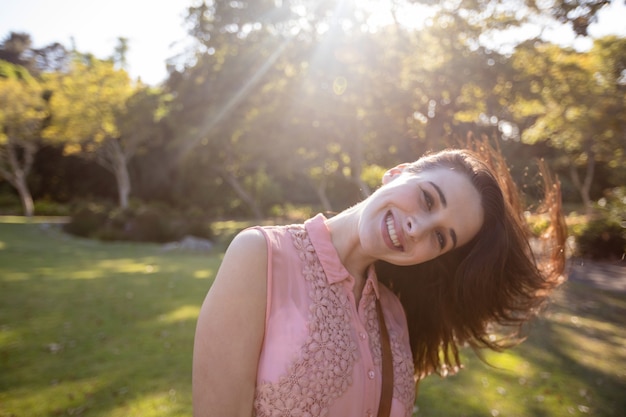 Portrait of beautiful woman swaying her hair in the park