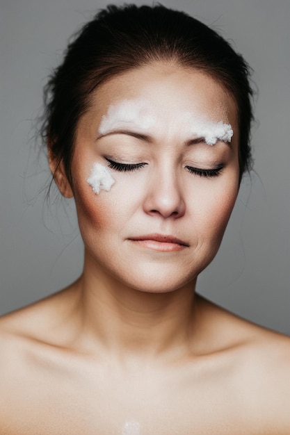 Portrait of a beautiful woman with closed eyes and snow on her face Winter makeup like a snow queen