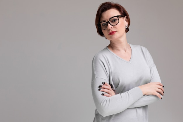 Portrait of beautiful woman with glasses isolated on light 