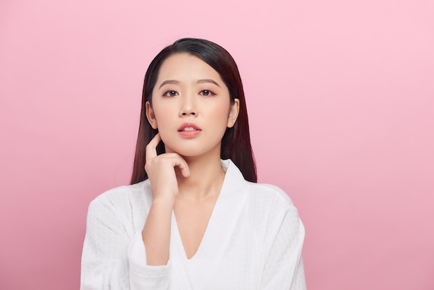 Portrait of beautiful woman with natural make up touching her face