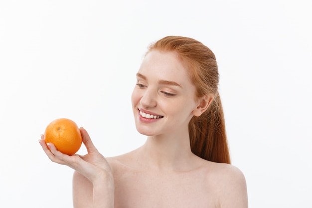 Portrait beautiful woman with a orange isolated.