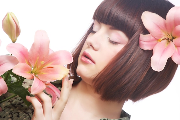 Portrait of beautiful woman with pink lily flower