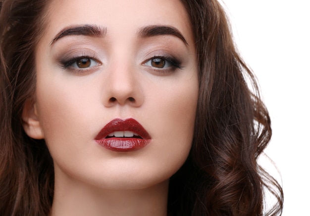 Portrait of beautiful woman with red lips on white