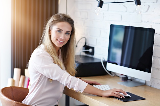 Portrait of beautiful woman working in modern home office