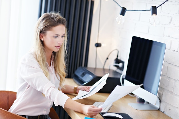 Portrait of beautiful woman working in modern home office