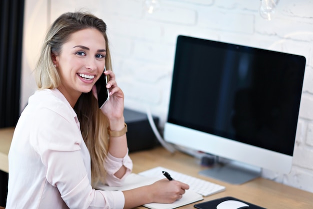 Portrait of beautiful woman working in modern home office