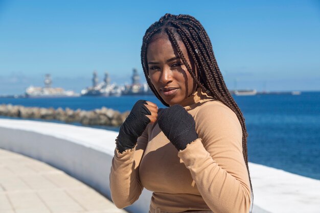 Portrait of beautiful young afro american woman , with bandages on her hands to practice martial arts, boxing. 