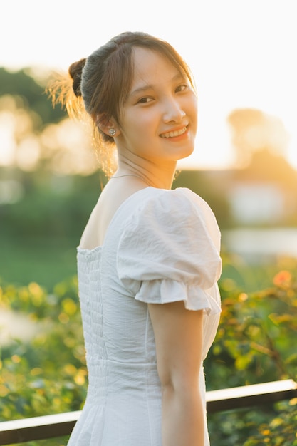 Portrait of a beautiful young Asian girl in the sunset