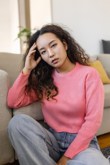 Portrait of beautiful young Asian woman looking at camera Beautiful woman smiling at home