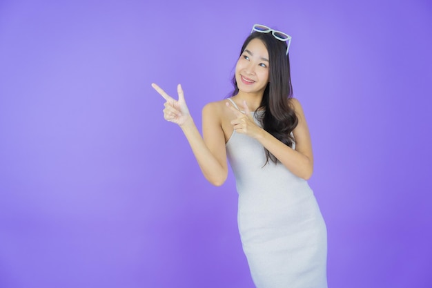 Portrait beautiful young asian woman smile with action on color background