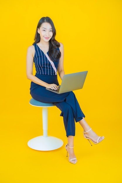 Portrait beautiful young asian woman smile with computer laptop on isolated background