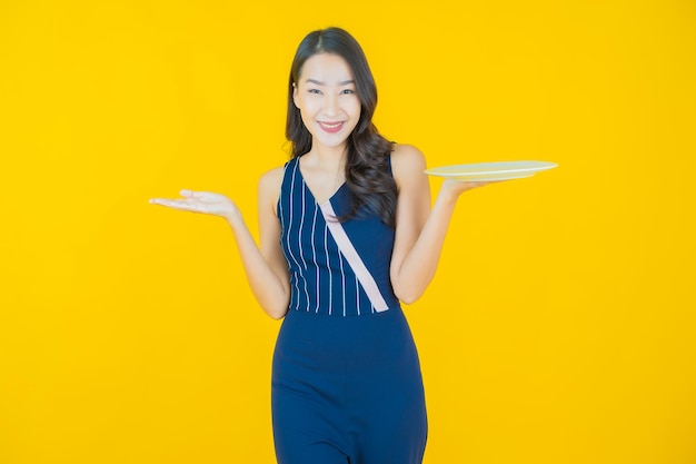 Portrait beautiful young asian woman smile with empty plate dish on