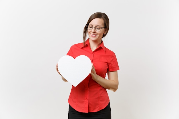 Portrait of beautiful young business teacher woman in red shirt, black skirt and glasses holding heart isolated on white background. Education or teaching in high school university concept. Copy space