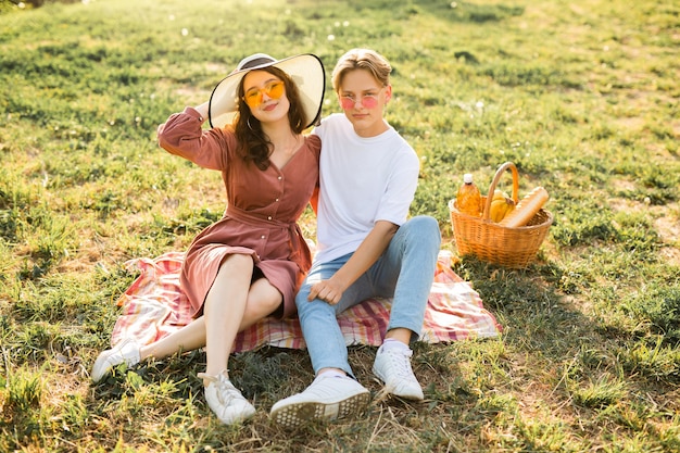 portrait of a beautiful young couple of man and woman in summer sunglasses