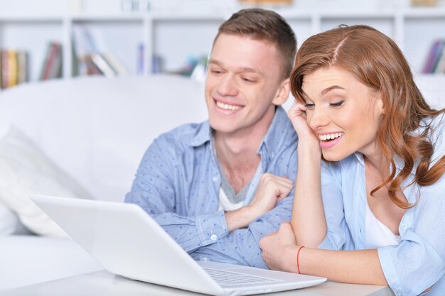 Portrait of a beautiful young couple with a laptop