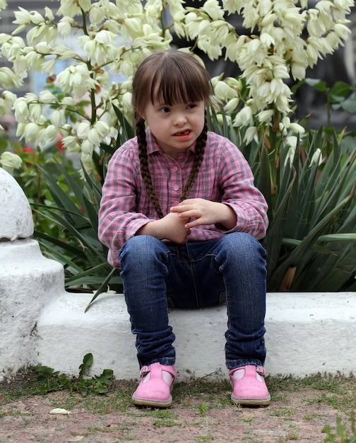 Portrait of beautiful young girl on flowers background