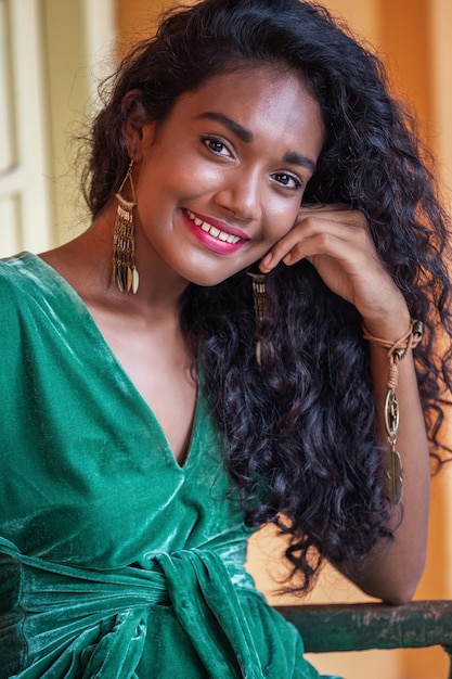 Portrait of a beautiful young girl from Sri Lanka in a green dress.