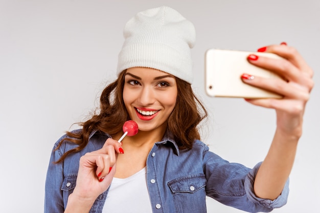 Portrait of a beautiful young girl making selfie.