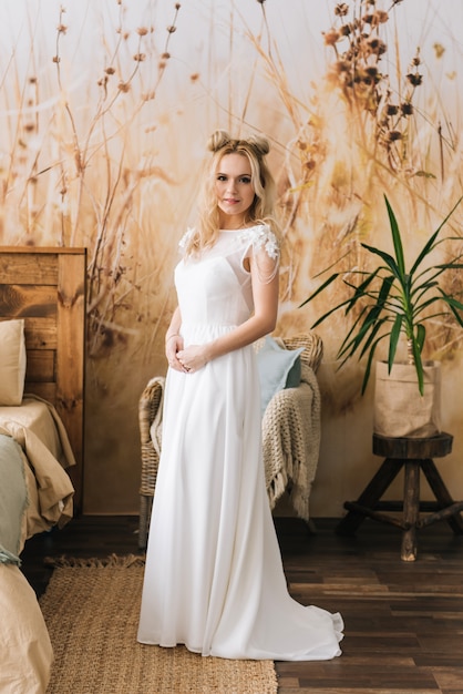 Portrait of beautiful young girl with long hair in white dress on beautiful background