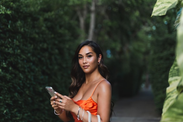 Portrait of beautiful young mixed race woman using cell phone